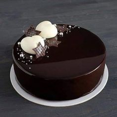 a chocolate cake with white frosting and decorations