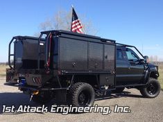 a black truck with an american flag on the back