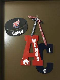 the wall is decorated with various sports related items and has a hat on top of it