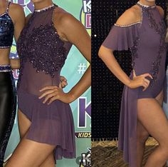 two women in purple dresses posing for pictures on the red carpet at an awards event