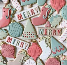 decorated christmas cookies on a table with merry words and ornaments in pastel blue, green, pink and white