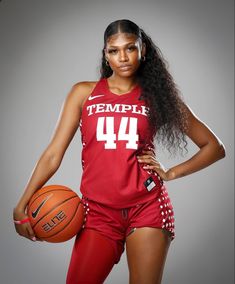 a woman holding a basketball in her right hand