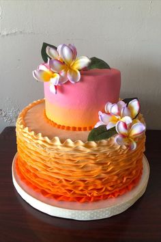 a three layer cake with flowers on top