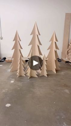 a group of wooden trees sitting on top of a floor