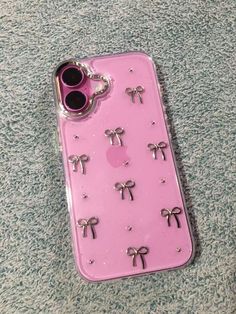 an iphone case with pink and silver decorations on it