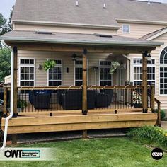 a house with a deck and railings in the front yard