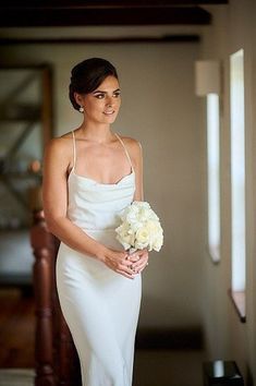 a woman in a white dress holding a bouquet