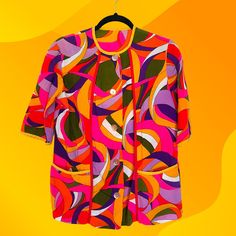 "Amazing groovy smock button down shirt, handmade from 1960's-1970's! Features bright bold and colorful abstract pattern of purple, pink, yellow, white, and green. No tags but feels like cotton and fits like a women's small/medium. Due to the secondhand nature of this vintage item, there are some light signs of wear like discoloration (pictured) and thinning of fabric. MEASUREMENTS WHEN LAID FLAT: 19\" from pit to pit 16\" from shoulder to shoulder 27\" from top of back collar to bottom hem" Multicolor Retro Print Button-up Top, Vintage Multicolor Blouse With Vibrant Print, Retro Pink Top With Retro Print, Vintage Pink Tops With Retro Print, Pink Vintage Tops With Retro Print, Retro Multicolor Print Collared Top, Retro Pink Button-up Blouse, Vintage Multicolor Tops With Vibrant Print, Retro Patterned Tops With Vibrant Print