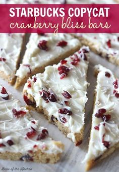 several pieces of cake with white frosting and cranberries