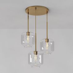 three clear glass lights hanging from a ceiling fixture