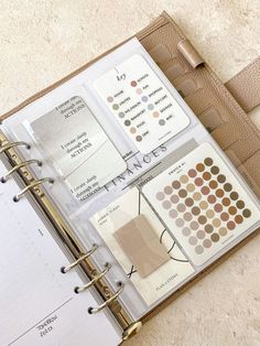 an open planner book with various items in it