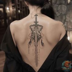 A striking tattoo of an intricate sword running down the spine, adorned with ornate details. This design is perfect for those wanting a feminine yet powerful look. Save this pin and visit inktat2.com for more amazing tattoo ideas. Female Spine Tattoos, Bookish Tattoos, Tattoo Female, Detailed Tattoo, Badass Tattoos