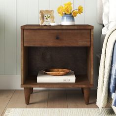 a wooden nightstand with a bowl on it