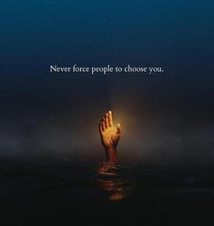 a person's hand reaching out into the water with an inspirational quote above it