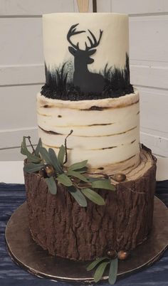 a three tiered cake with an antelope design on it