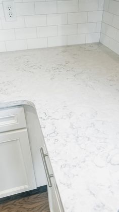 a kitchen counter with white marble on it