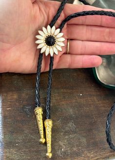 This awesome bolo tie is handmade in our shop, it has a black and white daisy pendant and black leather adjustable cord. Quality guaranteed, picture does not do this buckle justice! We have matching belt buckles to pair! Victorian Tattoo, Black And White Daisy, Daisy Pendant, Tie For Women, Bolo Ties, Bolo Tie, White Daisy, Leather Gifts, Tie Accessories