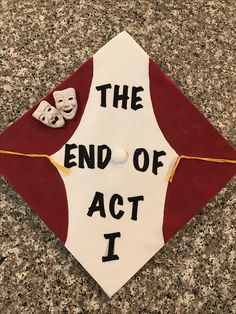 a red and white graduation cap that says the end of act i