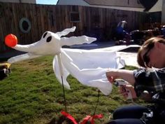 a woman is playing with an inflatable ghost