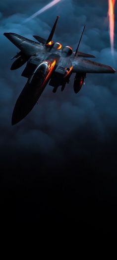 a fighter jet flying through the sky at night