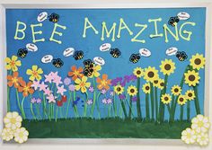 a bulletin board with flowers and bees in the grass that says bee amazing on it