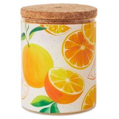 an orange and lemon canister with cork lid on a white background that is decorated with green leaves and oranges