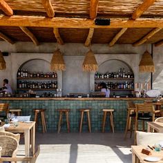 an outdoor bar with wicker chairs and tables