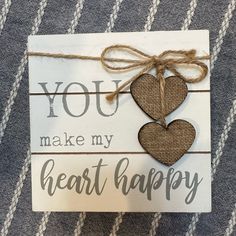 a card with two hearts attached to it that says you make my heart happy