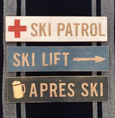 three wooden signs that say ski patrol, ski lift, aprress ski and ski