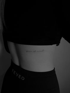 black and white photo of a woman's stomach with the word love written on it