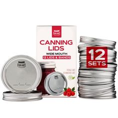 two jars of canning lids next to each other on a white background with red berries