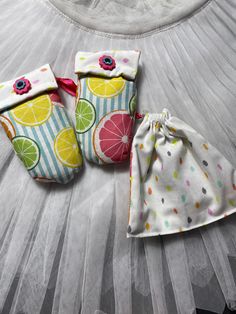 three baby cloths are laying on a bed with tulle skirt and one is in the shape of a lemon slice