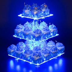 three tiered cupcake display with blue frosting