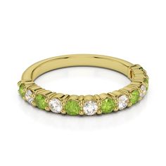 a yellow gold ring with green and white stones