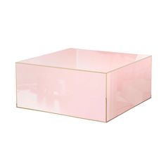 a pink square box with gold trim on the top and bottom, sitting in front of a white background