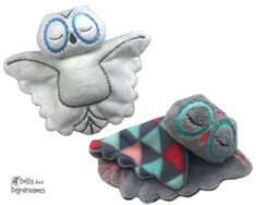 two small stuffed animals with eyes and wings