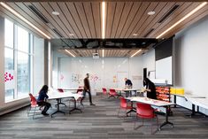 people are sitting at desks in an office