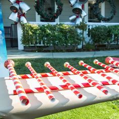 an outdoor game set up with candy canes in front of a christmas card on the lawn