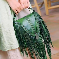 Such a Beautiful Leather Fringe Shoulder Bag with matching Bamboo Handle!Retro Style: Handbag comes with bamboo top-handle, fashion fringes rivets, and leather removeable crossbody strap!Multi-color to choose. Dimensions: 8.3"L x 8.3"H x 6"WSturdy Hardware: Rivets of bag is as decor around the zipper; fine craftmanship as a key for long-term use.Daily Needs: This bag can hold a lot just as iPhone Plus, keys, lipsticks, sunglass ETC. Also, it suits any occasion like wedding, party, shopping or an Black Leather Fringe Bag, Recycled Bags, Leather Fringe Bag, Fall Handbags, Bamboo Bag, Fringe Purse, Hippie Look, Vogue Dress, Lv Bags