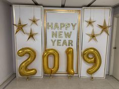 two golden balloons in the shape of numbers are next to a new year's card