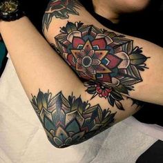 a woman with tattoos on her arms and arm