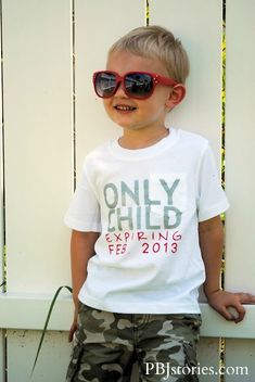 a young boy wearing sunglasses leaning against a white fence with the words only child spring fest 2013 printed on it