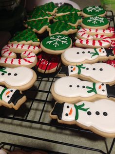 some decorated cookies are on a cooling rack