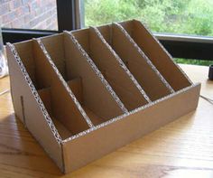 an open cardboard box sitting on top of a wooden table