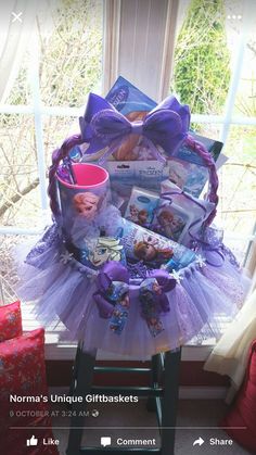 a purple tutule sitting on top of a stool next to a window