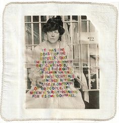 a black and white photo of a woman with words written on her shirt in front of a jail cell