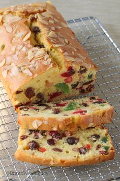 a loaf of fruit bread sitting on top of a cooling rack