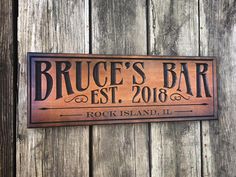 a wooden sign that says bruce's bar on it