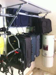 several pieces of luggage are hanging on the wall