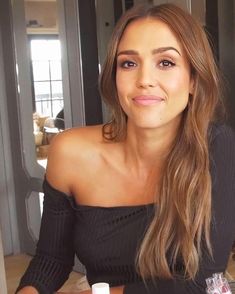 a beautiful young woman sitting at a table